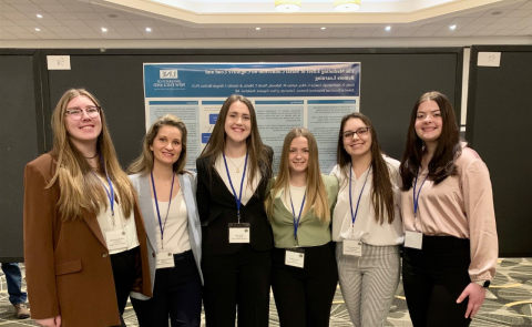 Five women students and a professor pose at the Eastern Psychological Association conference